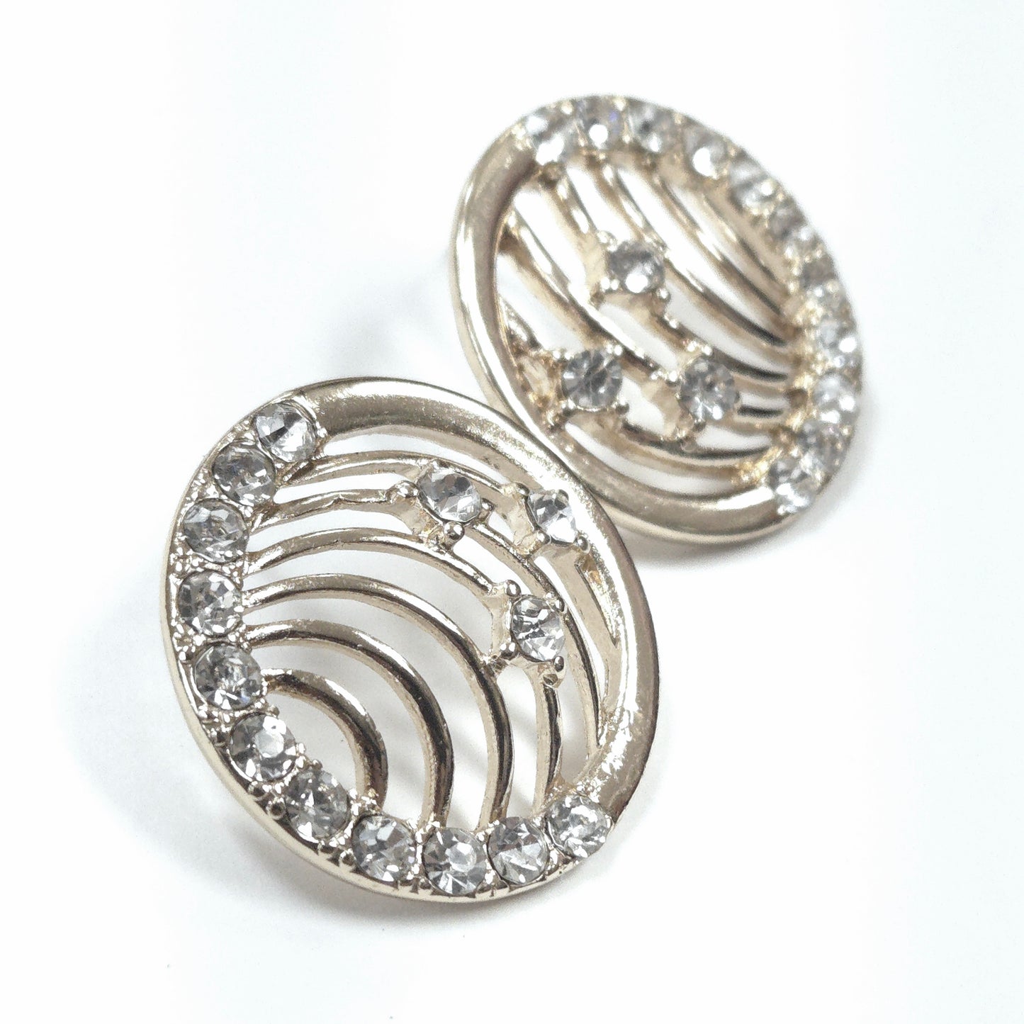 Silver earrings with crystal embellishments on a white background