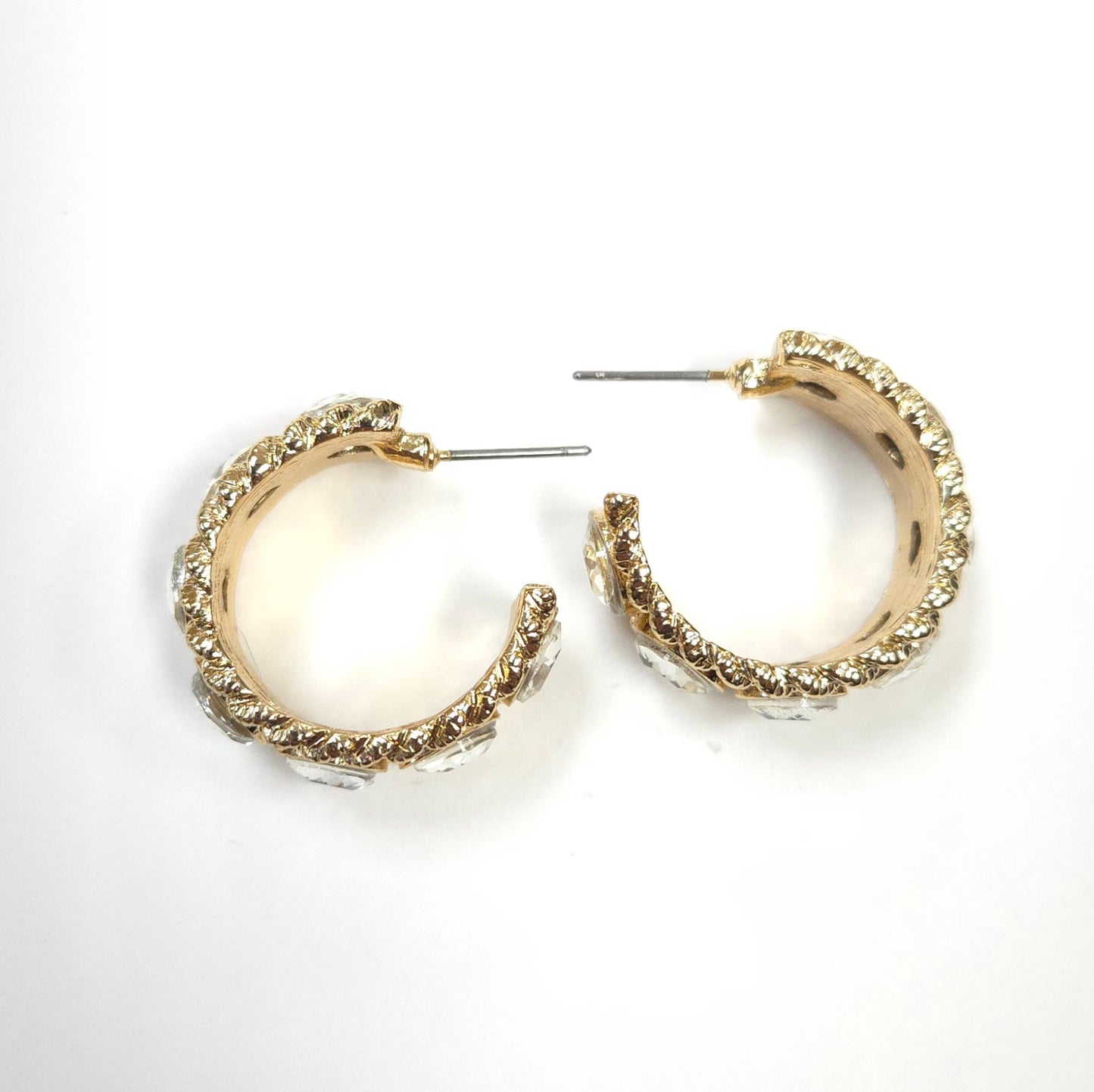 Gold hoop earrings on a white background