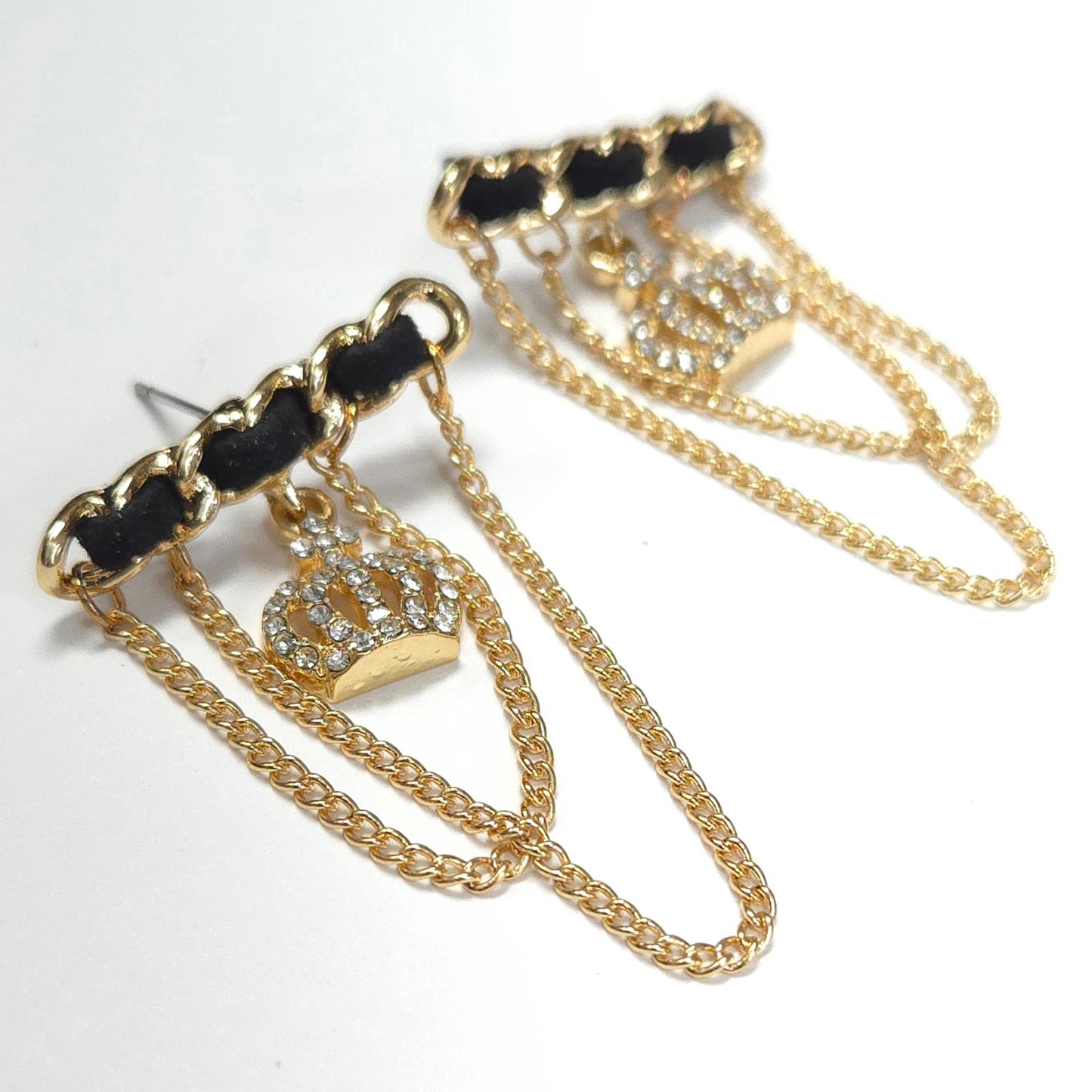 Pair of gold chain earrings with crown designs on a white background
