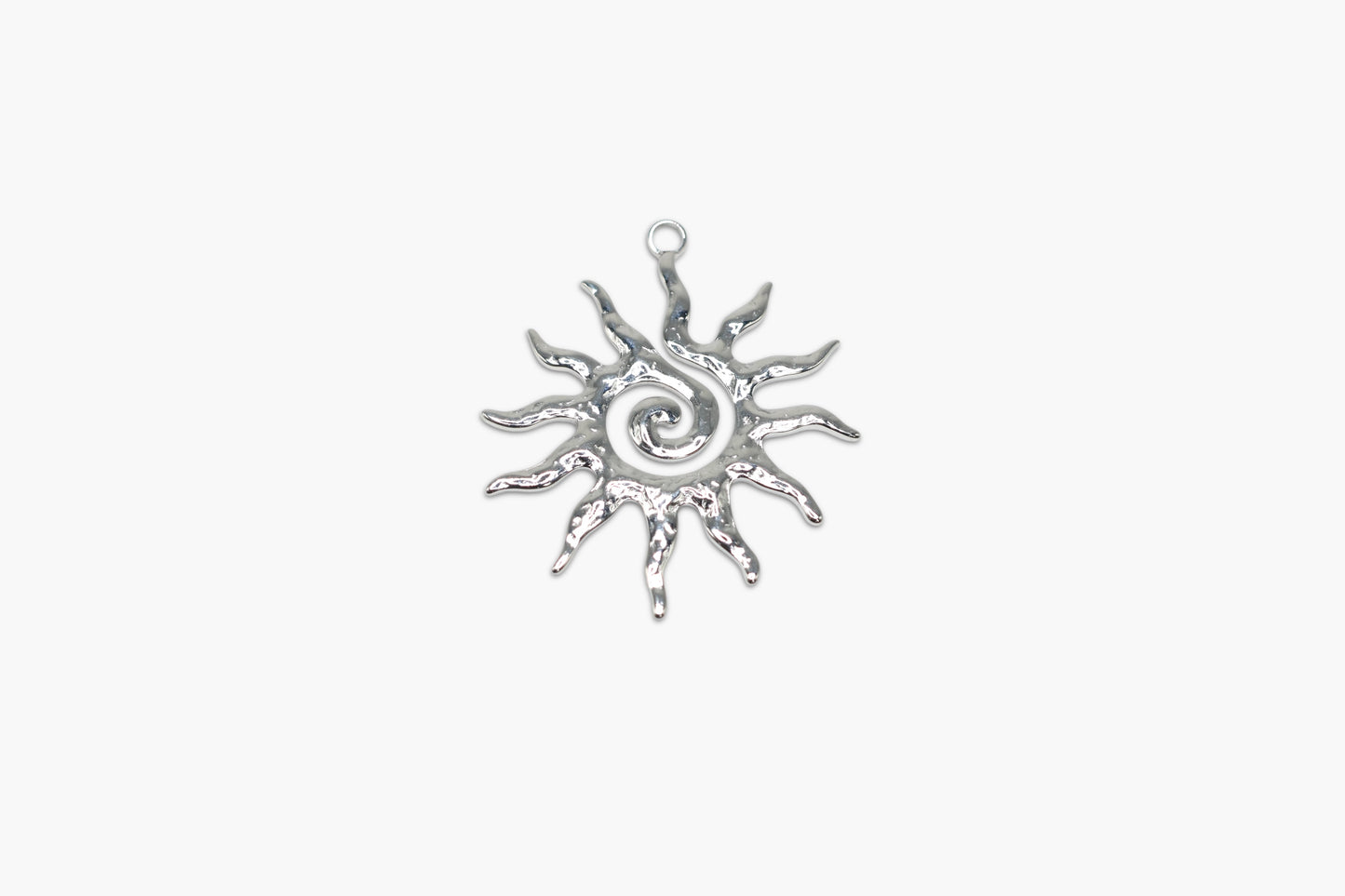 Silver sun-shaped pendant on a white background