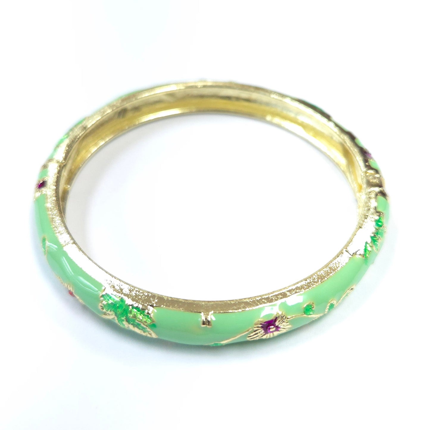 Green bangle with gold accents on a white background