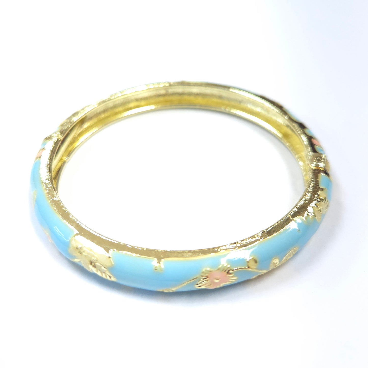 Gold and light blue bangle with floral patterns on a white background