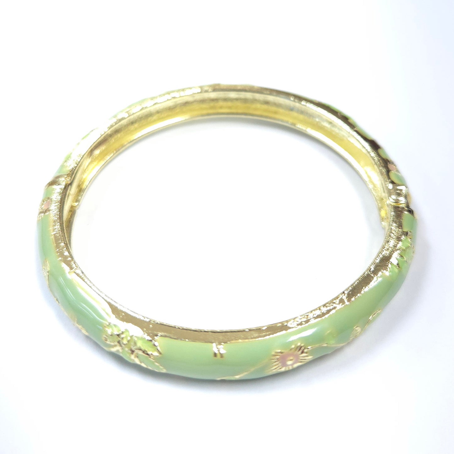 Gold and green bangle on a white background