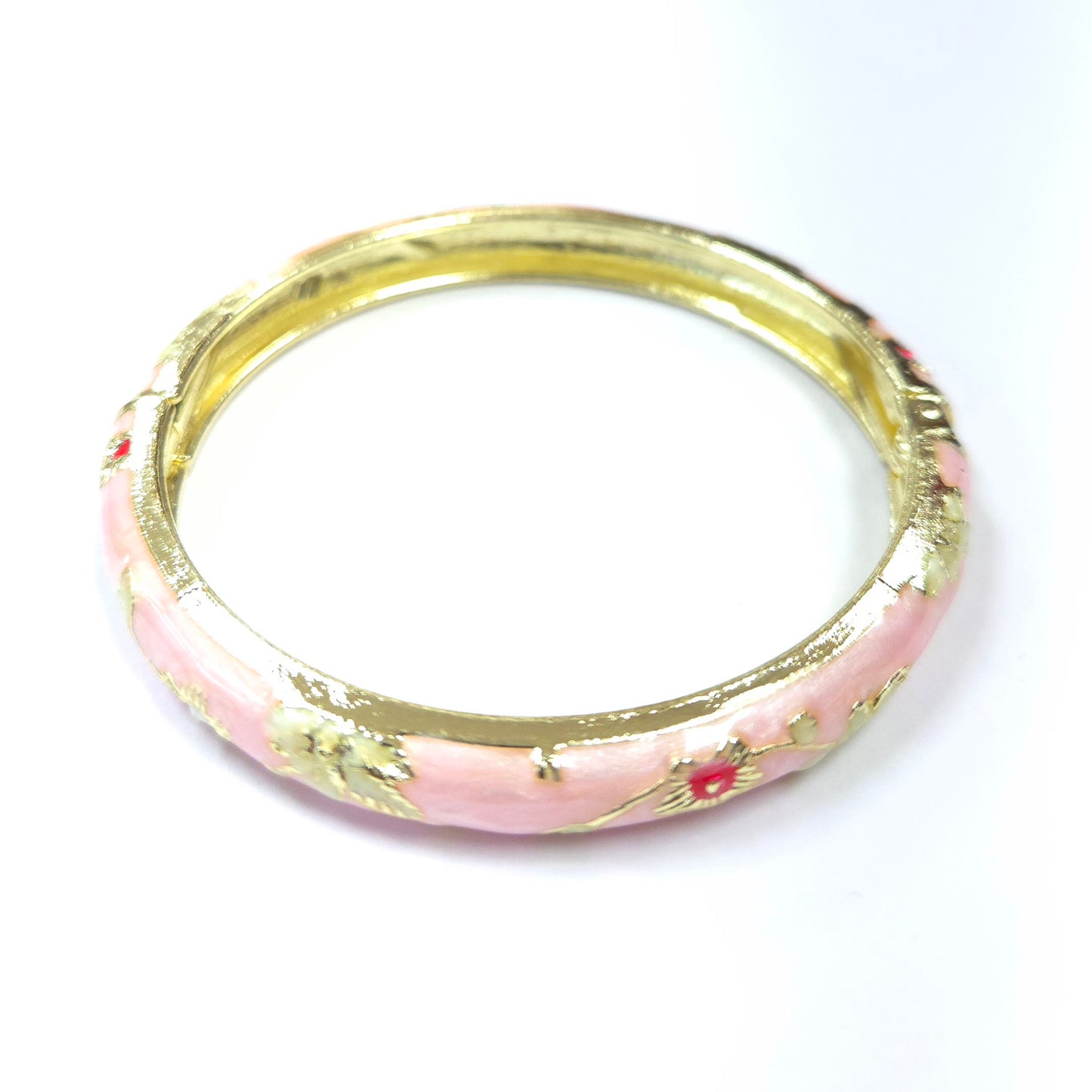 Gold and pink bangle on a white background