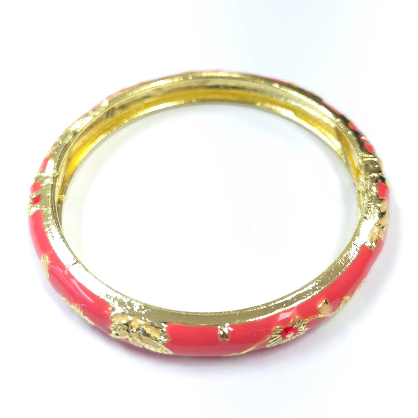 Red bangle with gold accents on a white background