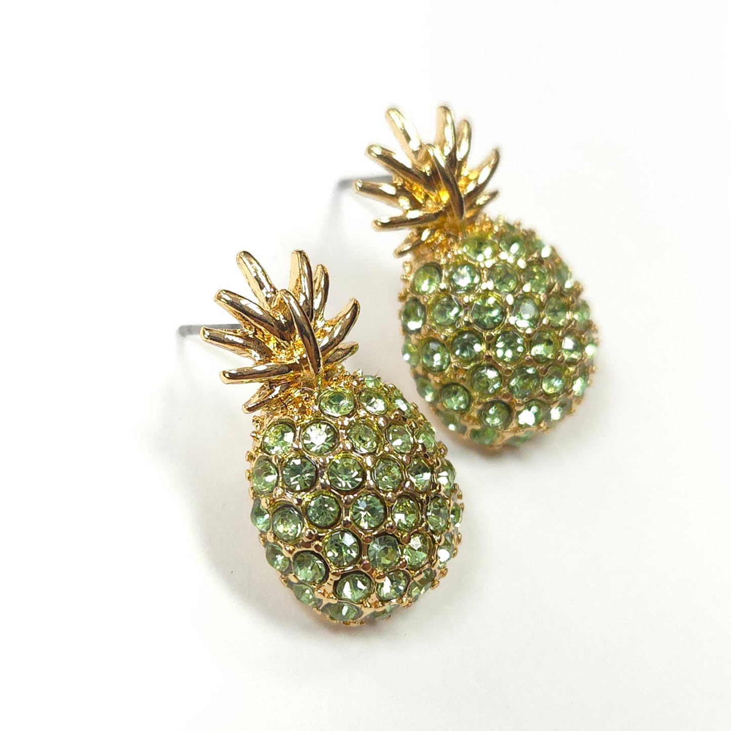Pineapple-shaped earrings with green gemstones on a white background