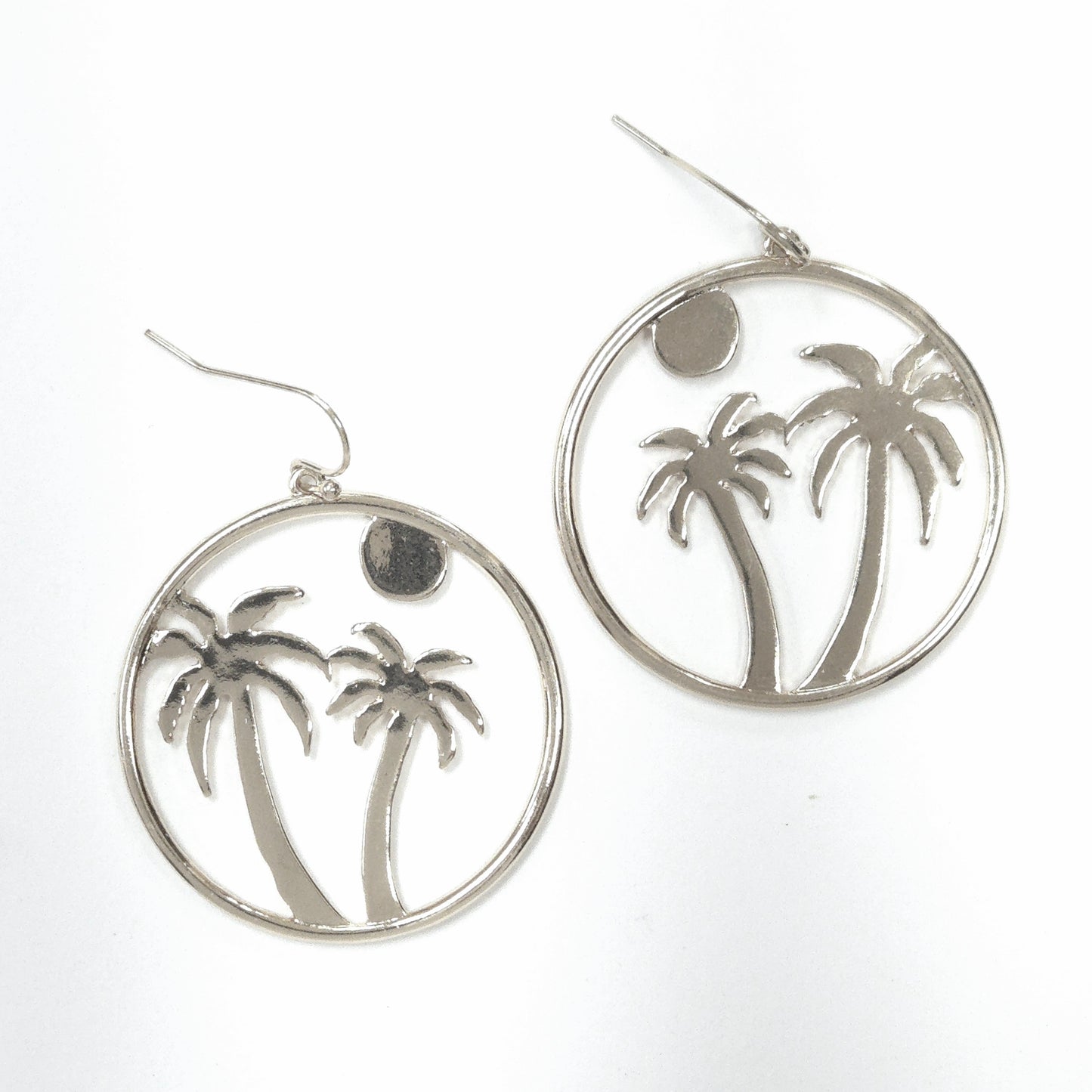 Silver hoop earrings with palm tree design on a white background