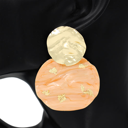 Earring with peach and yellow design on a black background