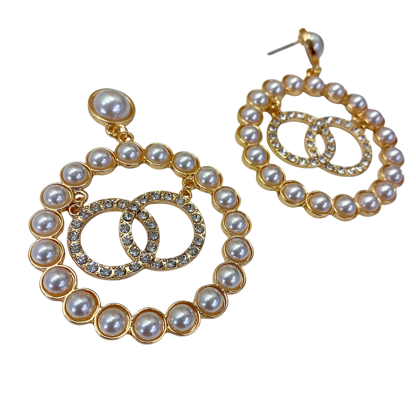 Pair of pearl and gold hoop earrings on a white background