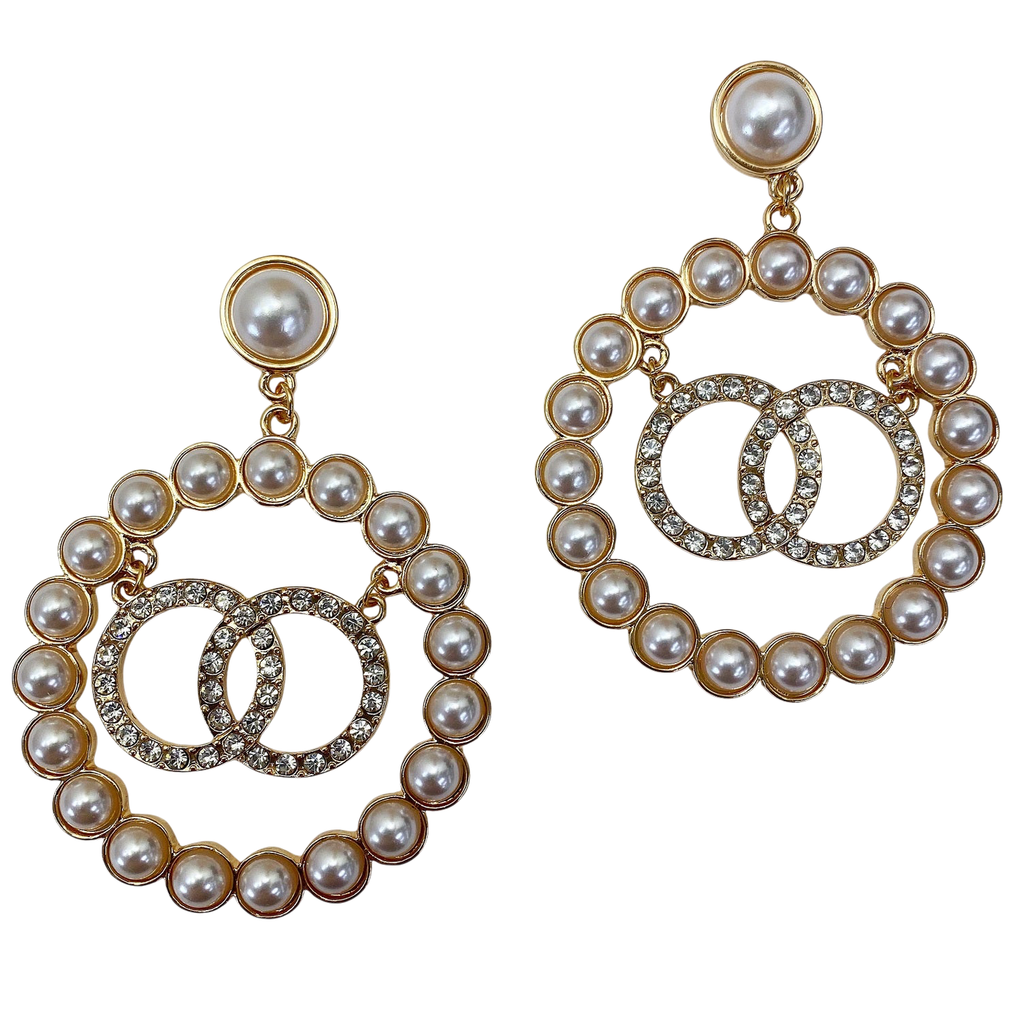 Pair of pearl and gold hoop earrings on a white background