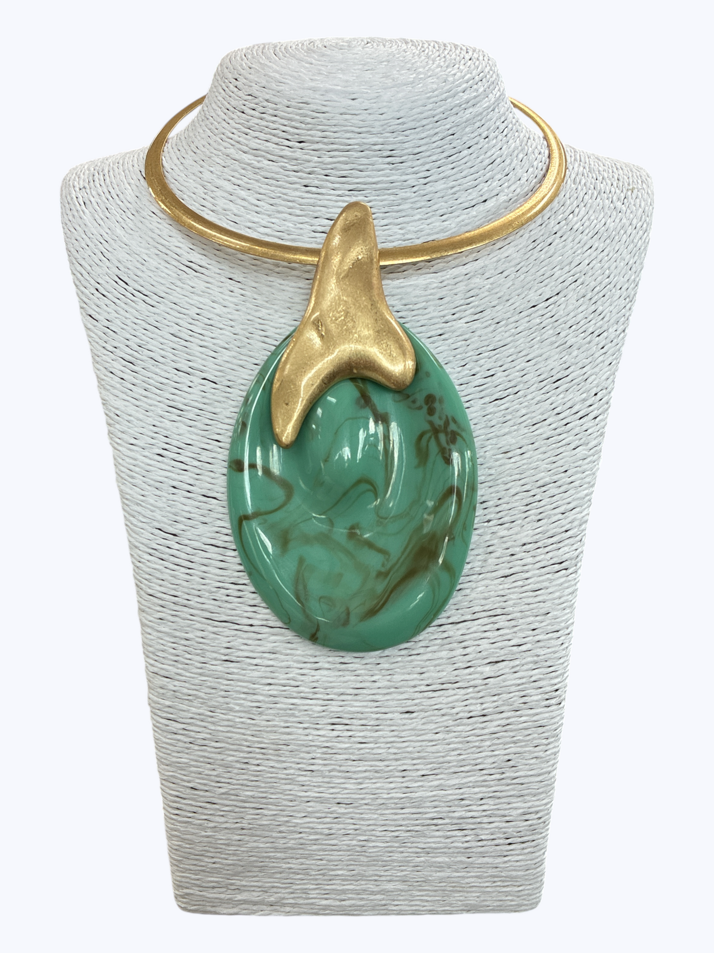 Modern sculptural collar necklace with oversized marbled resin teardrop pendant and metallic abstract accent displayed on mannequin bust.