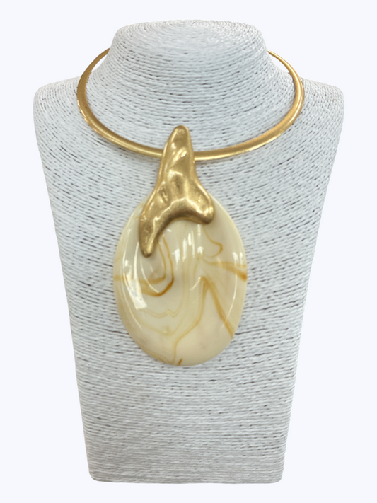 Modern sculptural collar necklace with oversized marbled resin teardrop pendant and metallic abstract accent displayed on mannequin bust.