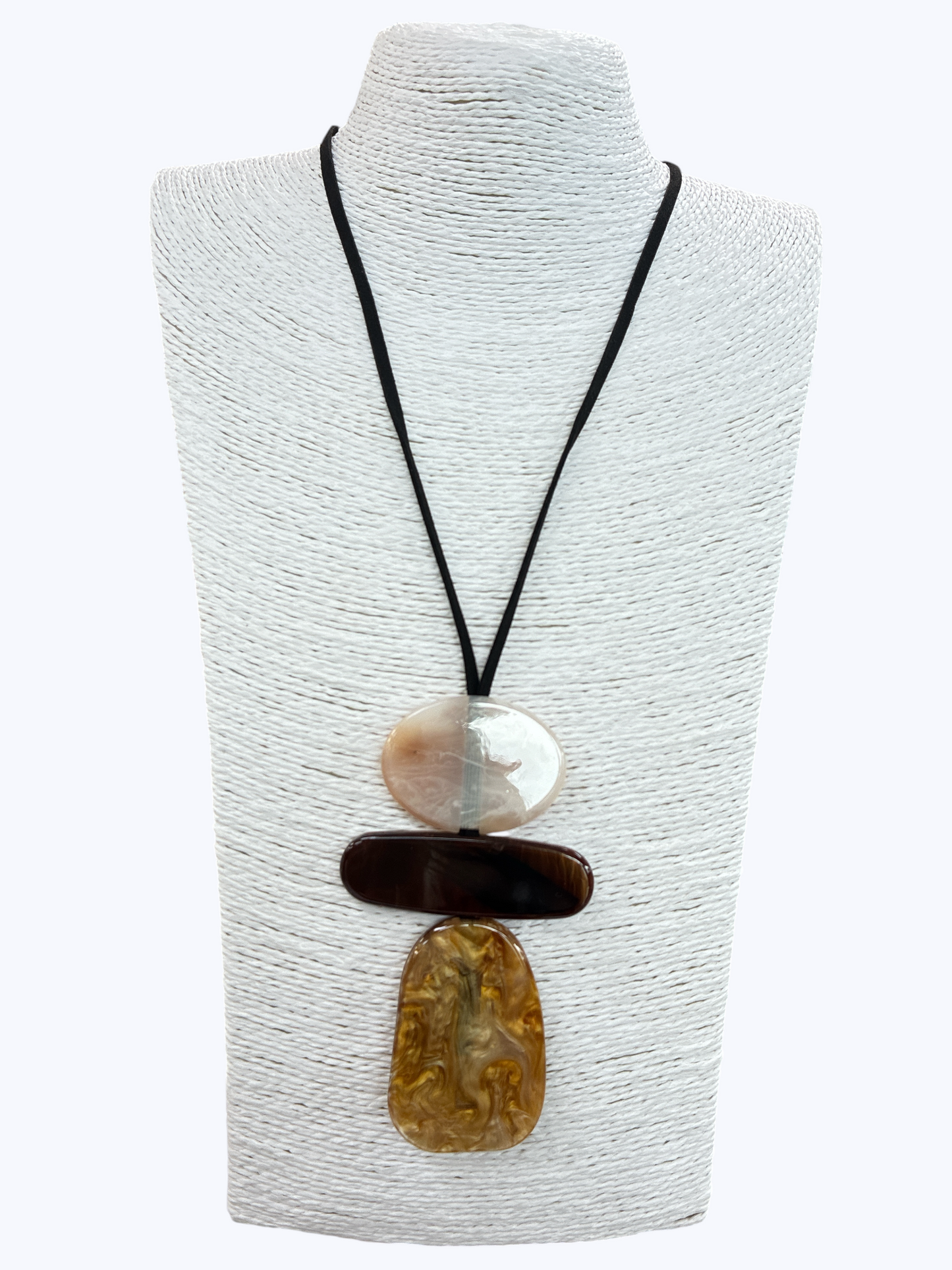 Abstract pendant statement necklace with layered resin geometric charms and minimalist black cord on mannequin display
