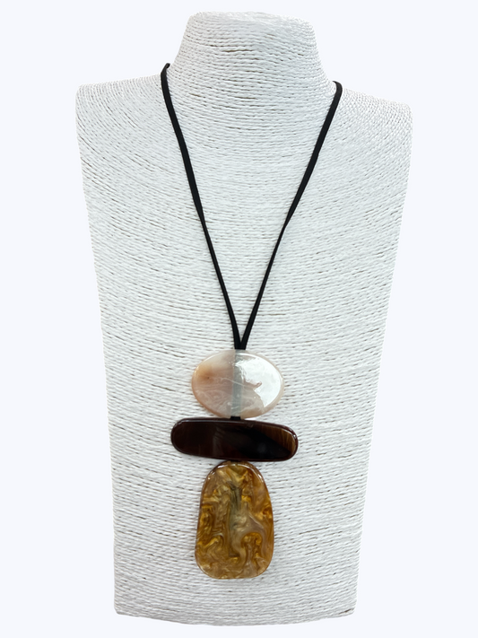Abstract pendant statement necklace with layered resin geometric charms and minimalist black cord on mannequin display