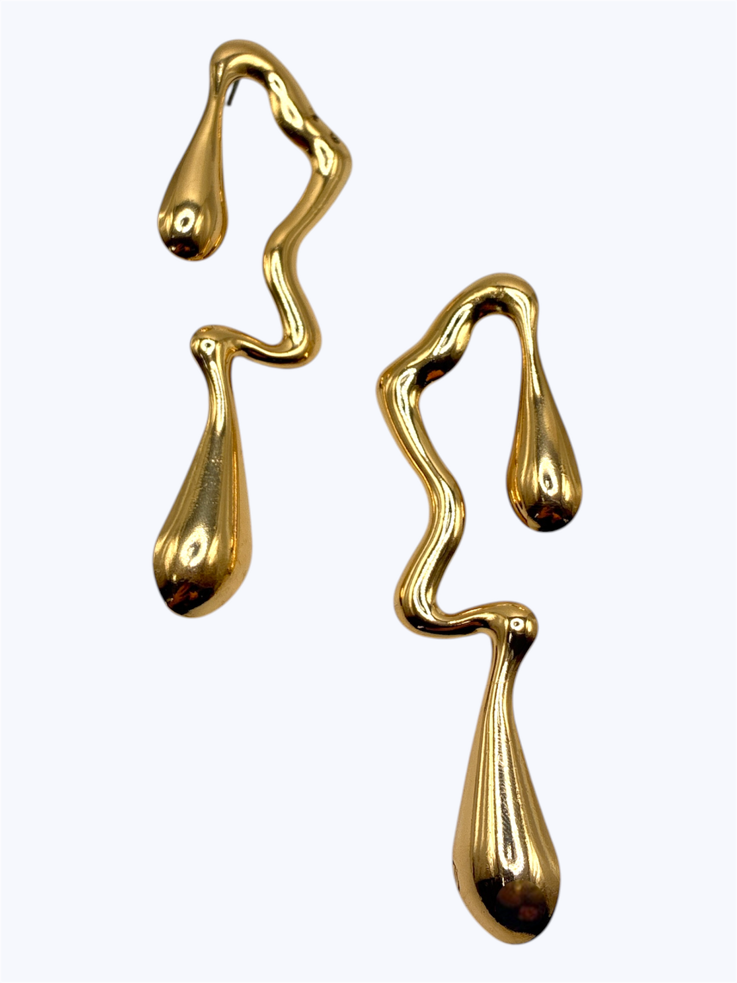 Abstract gold drop earrings with a fluid wavy silhouette and glossy teardrop pendants in a modern artistic design