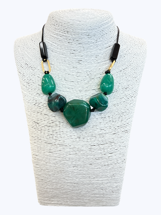 Green statement bead necklace with glossy marbled resin stones, black cord, and gold-tone accents for a bold contemporary boutique look.