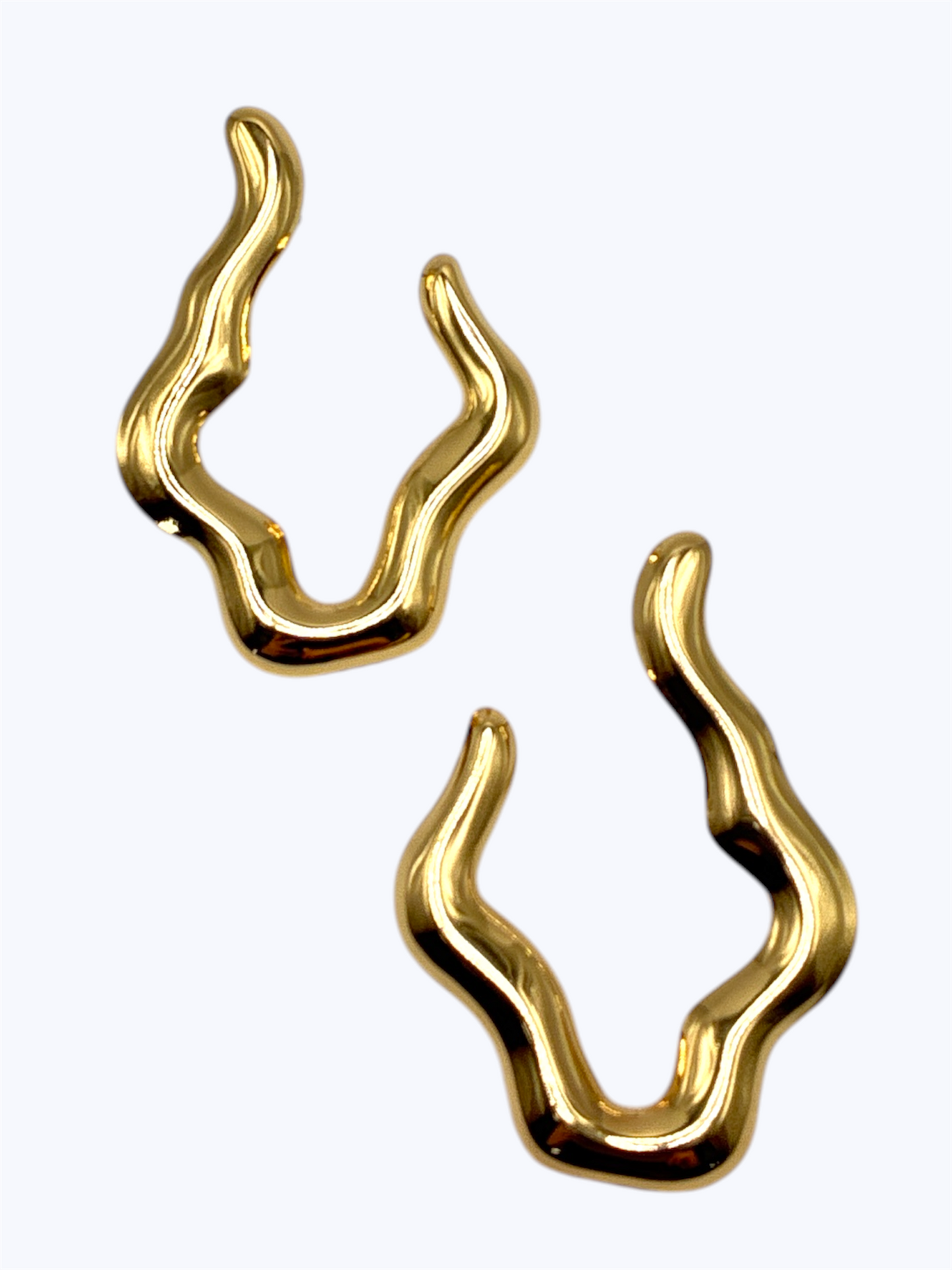 Gold abstract earrings on a white background