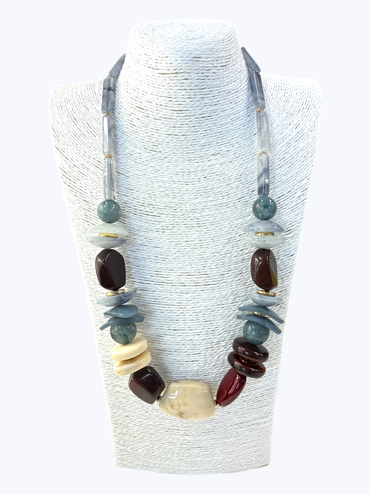 Necklace with multicolored beads on a white stand