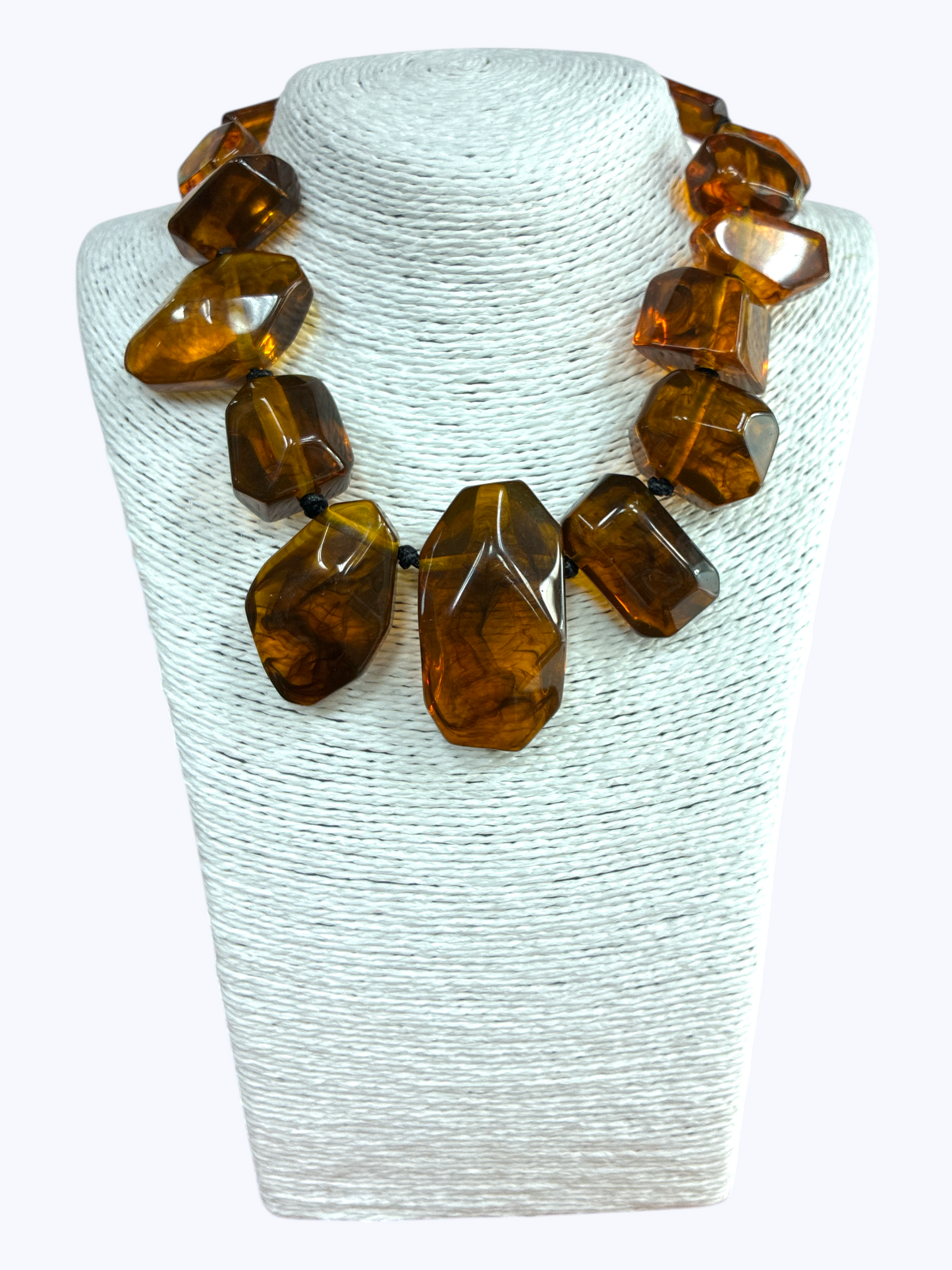 Chunky geometric acrylic necklace featuring oversized translucent faceted beads in a bold modern statement design.