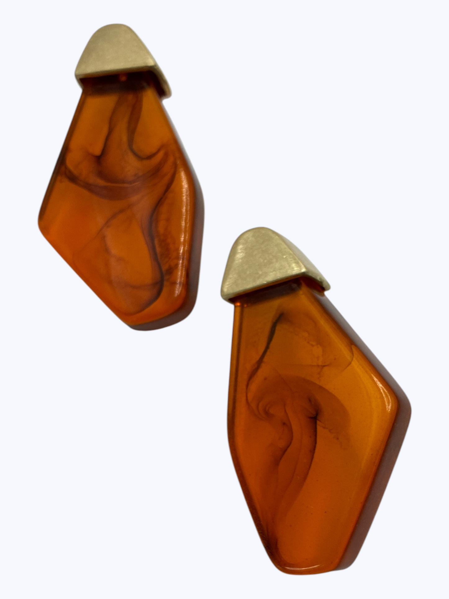 Modern geometric drop earrings featuring abstract marbled resin panels with metallic accent tops.