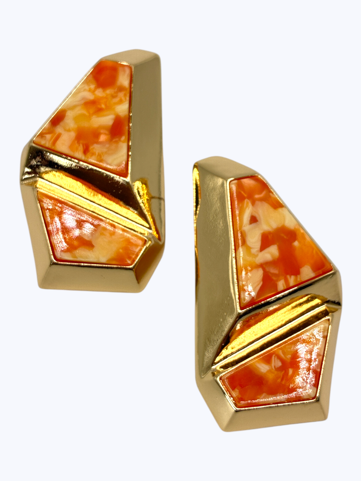 Bold geometric drop earrings featuring abstract multicolor resin mosaic panels framed by sculptural metallic design.