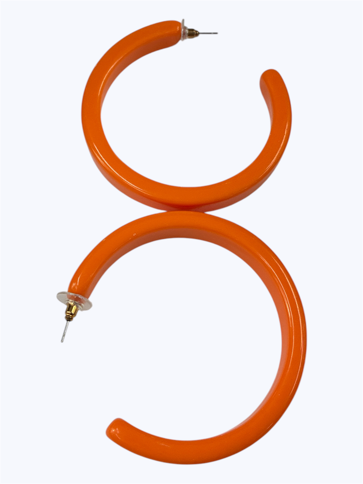 Bright orange open hoop earrings with a modern lightweight circular silhouette