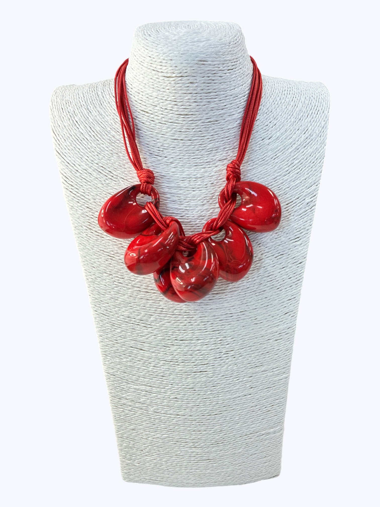 Red necklace on a white mannequin bust