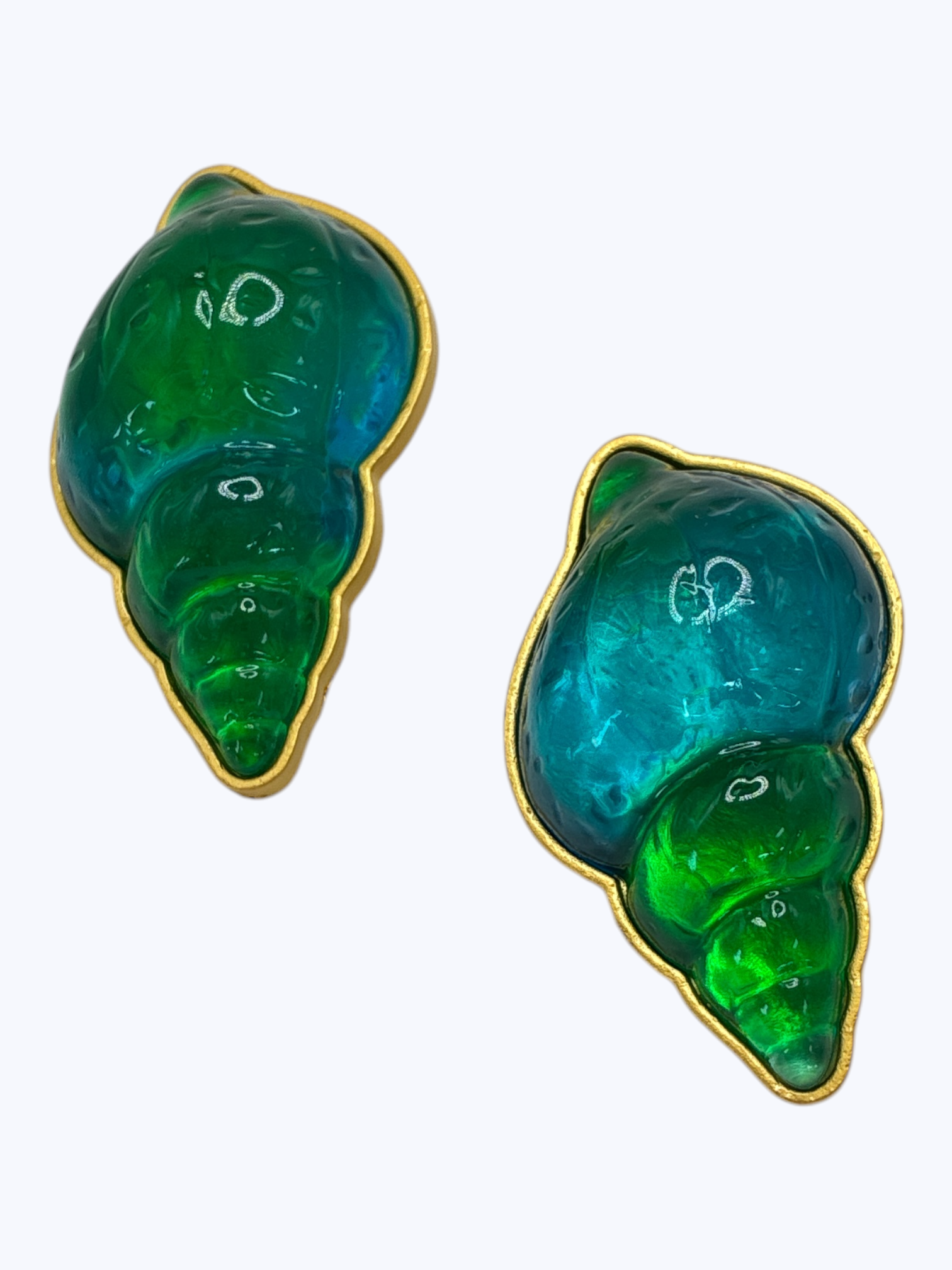 Pair of green shell-shaped earrings on a white background