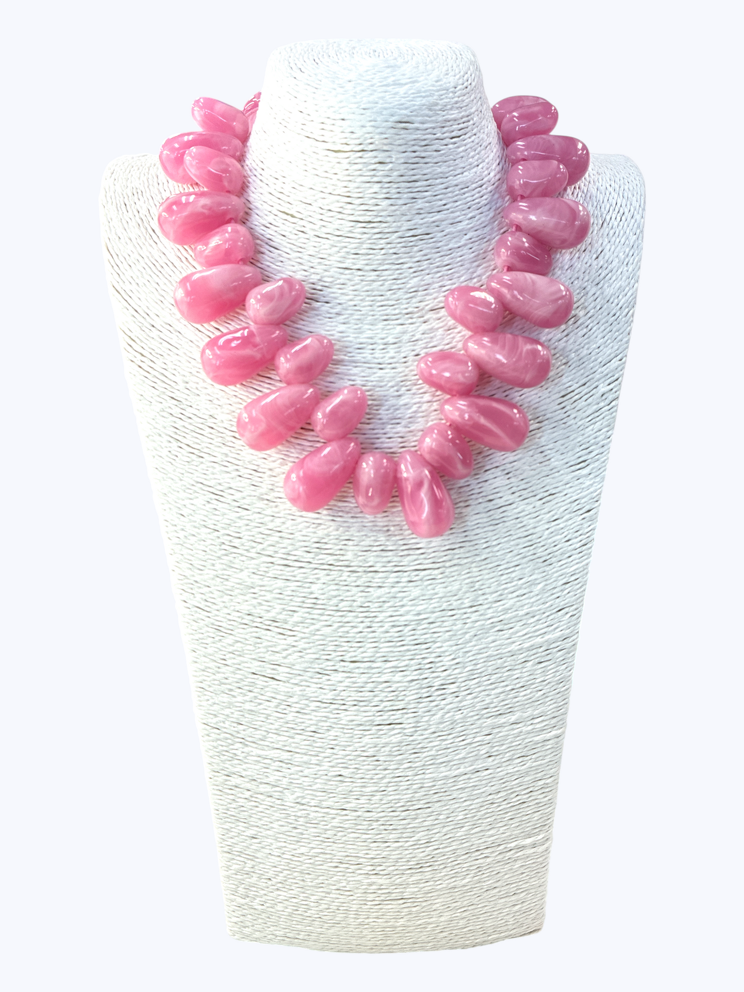 Necklace with pink beads on a white mannequin bust