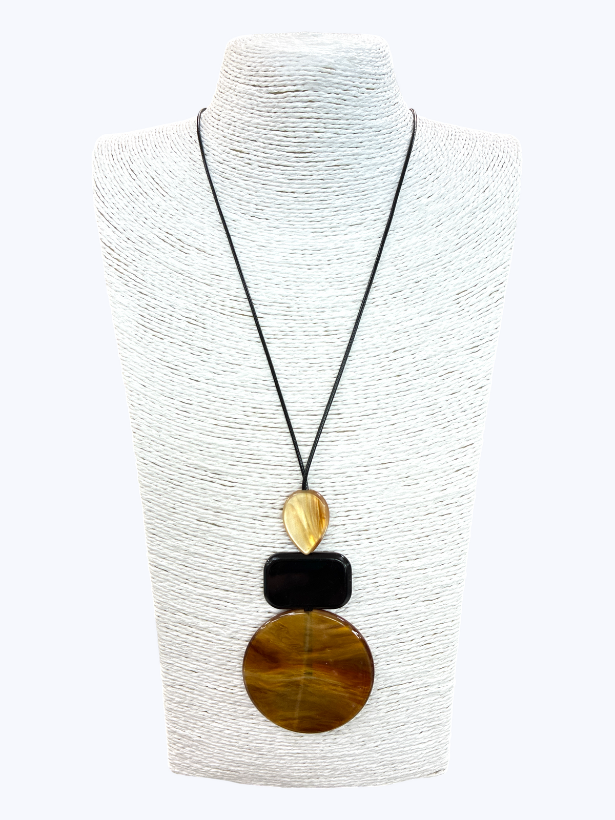 Geometric statement pendant necklace with marbled amber and black resin charms on a sleek black cord for a modern boutique-inspired style.