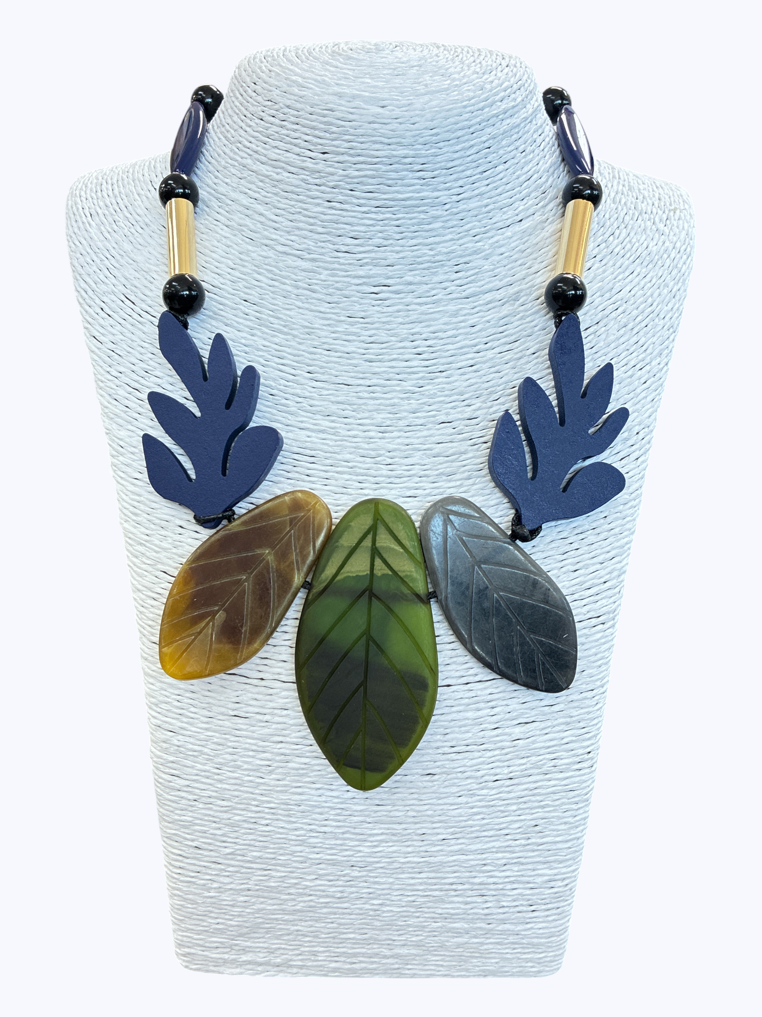 Abstract leaf statement necklace with marbled green and gray resin leaves, navy accents, and bold bead details for a modern artistic boutique style.