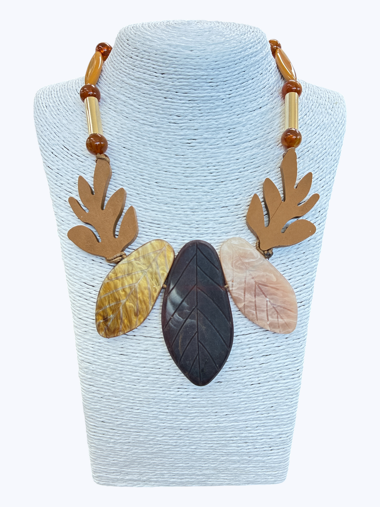 Abstract leaf statement necklace with marbled neutral resin leaves, wooden accents, and earthy bead details for a natural boutique-inspired look.