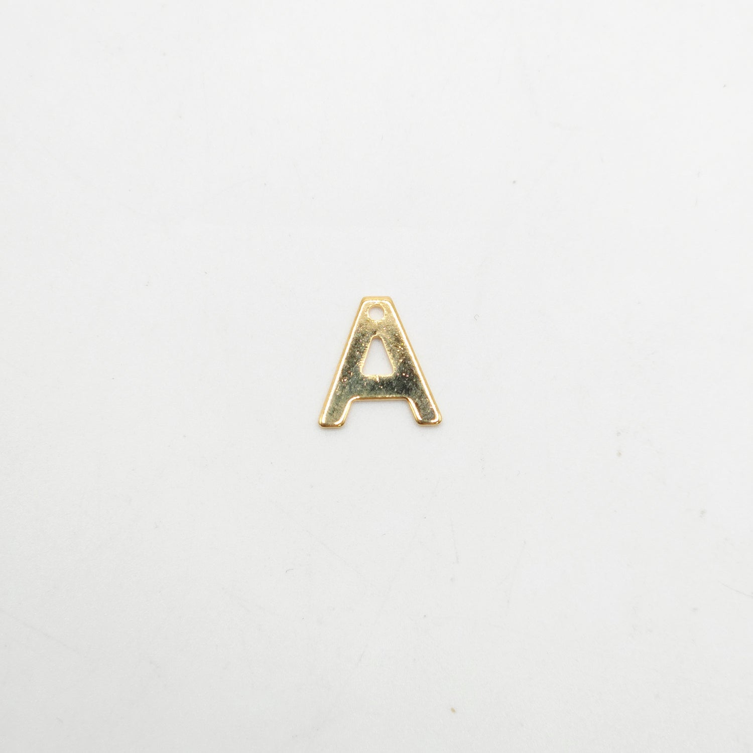 Gold letter 'A' charm on a white background