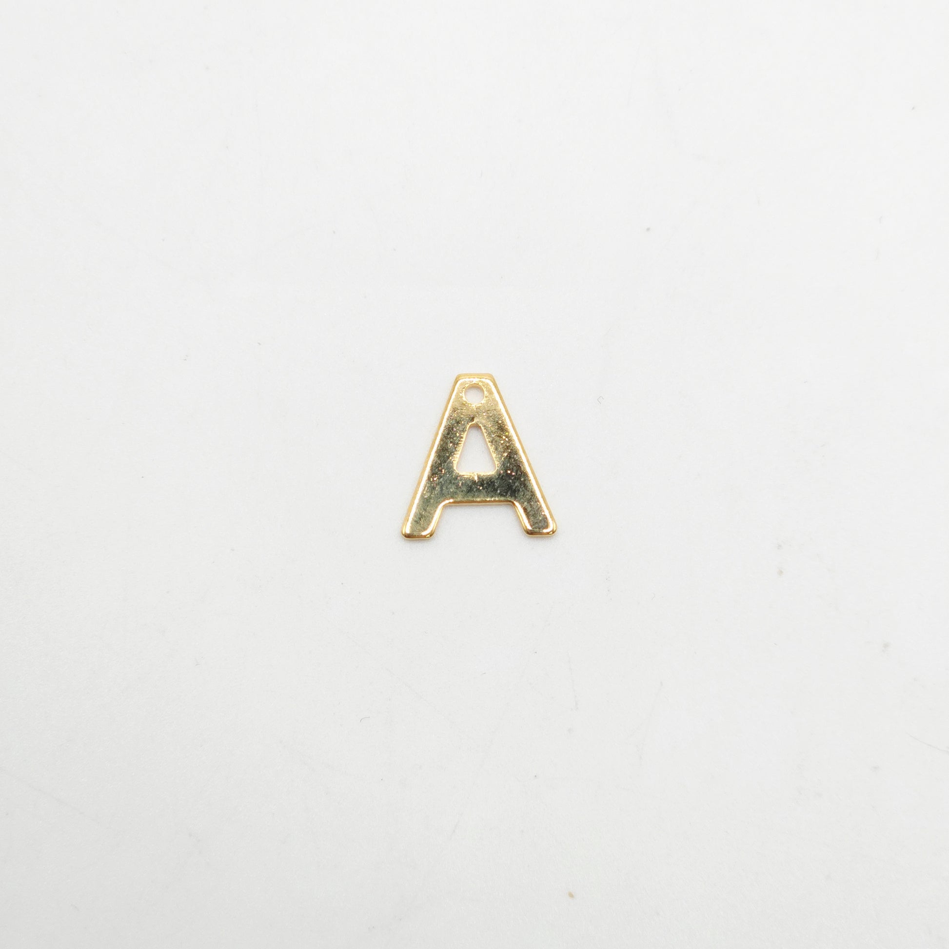 Gold letter 'A' charm on a white background