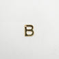 Gold letter 'B' charm on a white background