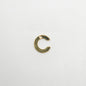 Gold letter 'C' charm on a white background