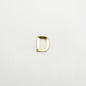 Gold letter 'D' charm on a white background