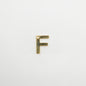 Gold letter 'F' charm on a white background