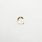 Gold letter 'G' charm on a white background