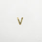 Gold letter 'V' charm on a white background