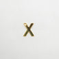 Gold letter 'X' charm on a white background