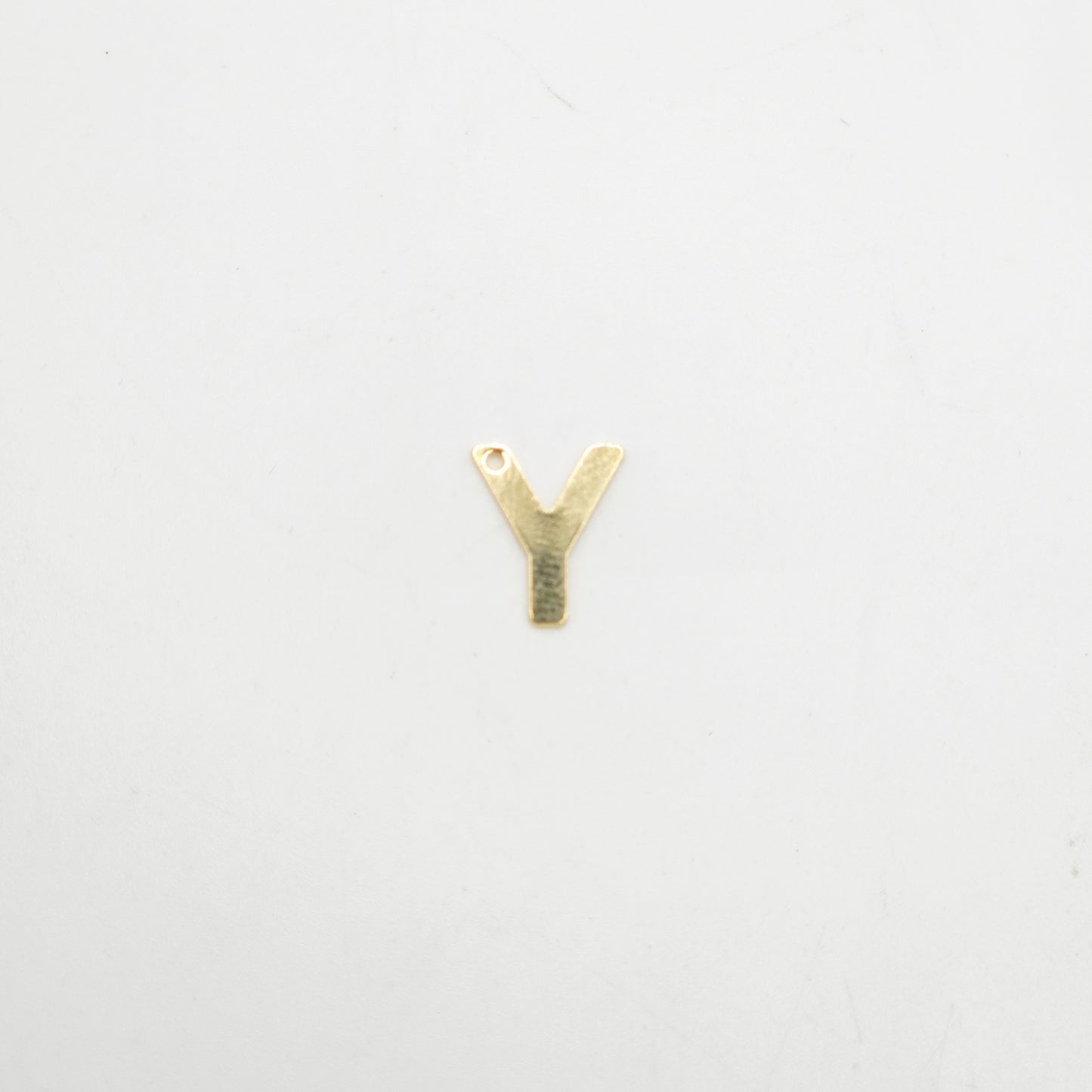 Gold letter 'Y' charm on a light gray background