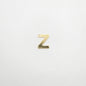 Gold letter 'Z' charm on a white background