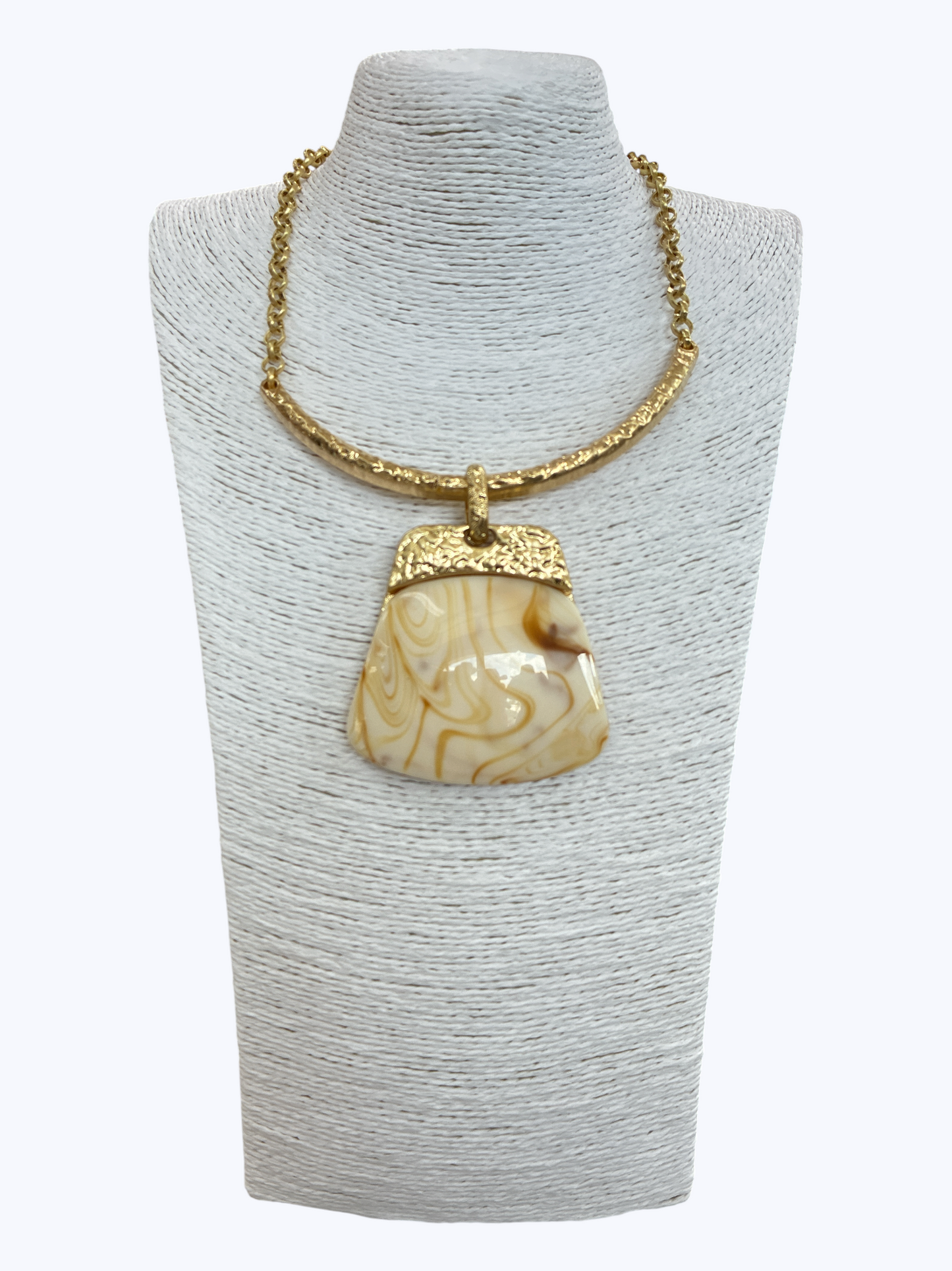 Modern boutique necklace featuring textured metallic collar chain with oversized faux amber resin geometric pendant.