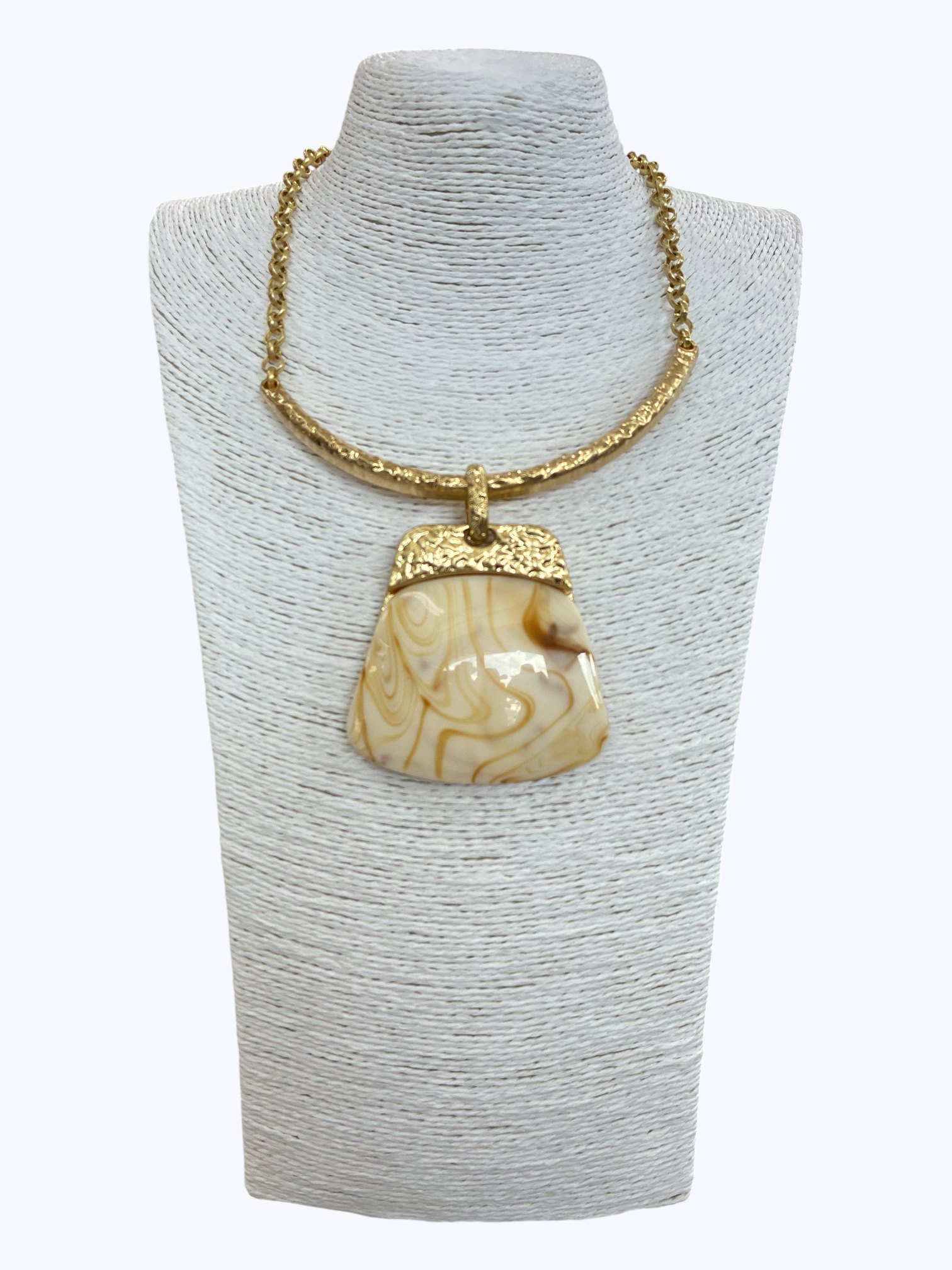 Modern boutique necklace featuring textured metallic collar chain with oversized faux amber resin geometric pendant.