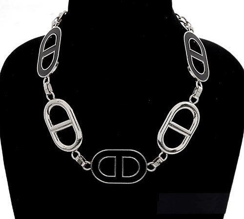 Silver chain necklace on a black mannequin