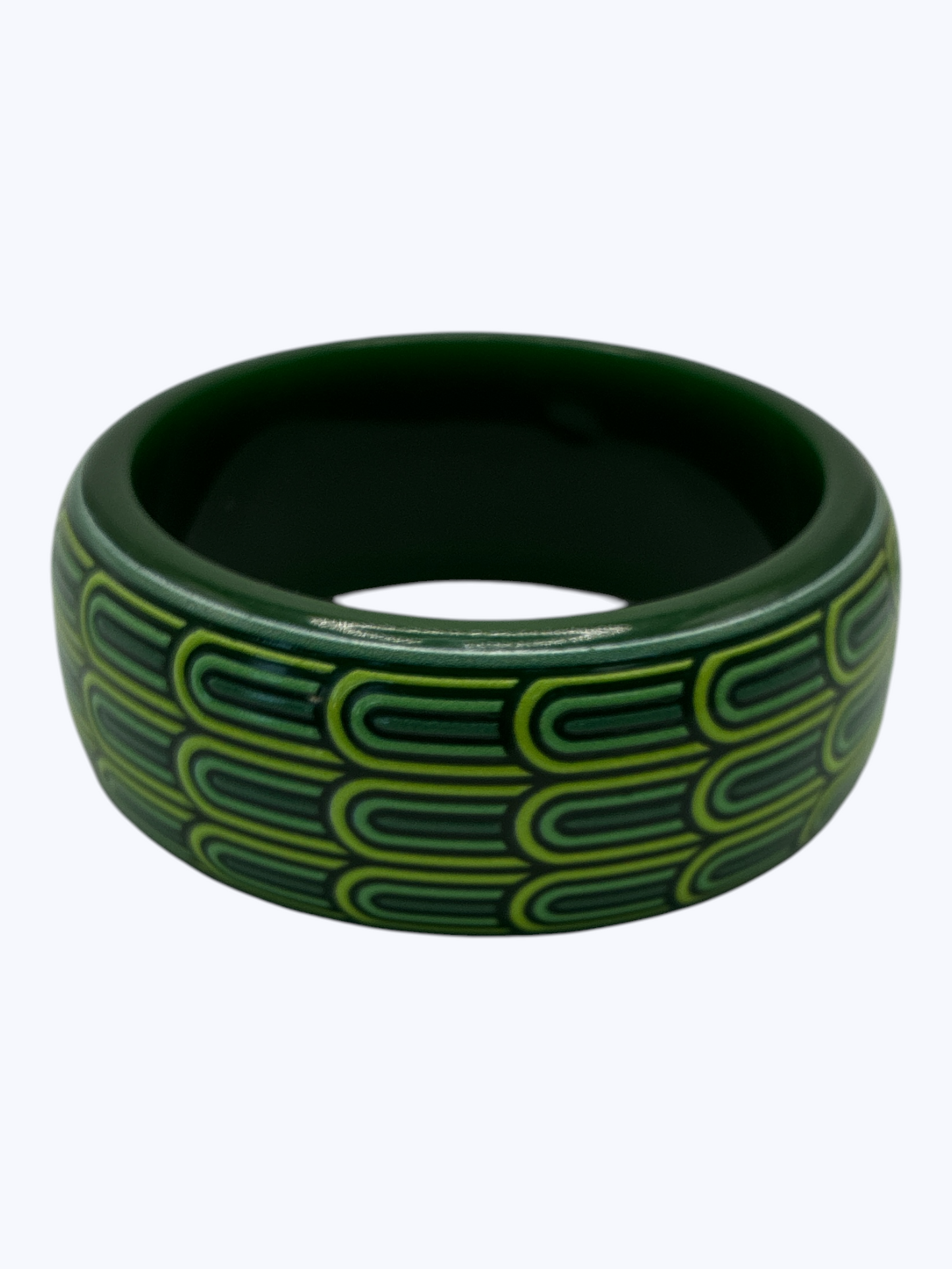 Green bangle with a pattern on a white background