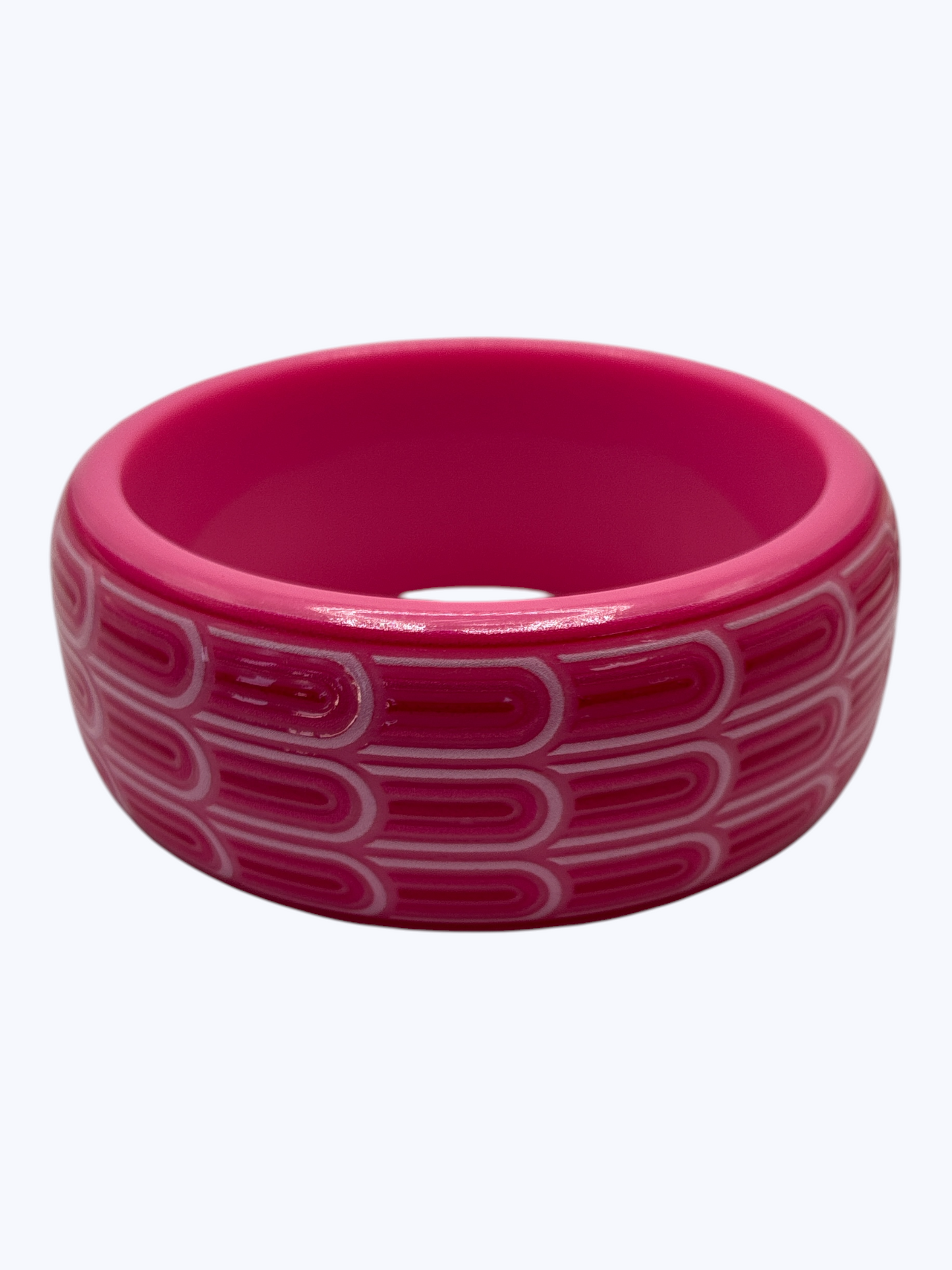 Pink ceramic bowl with a geometric pattern on a white background