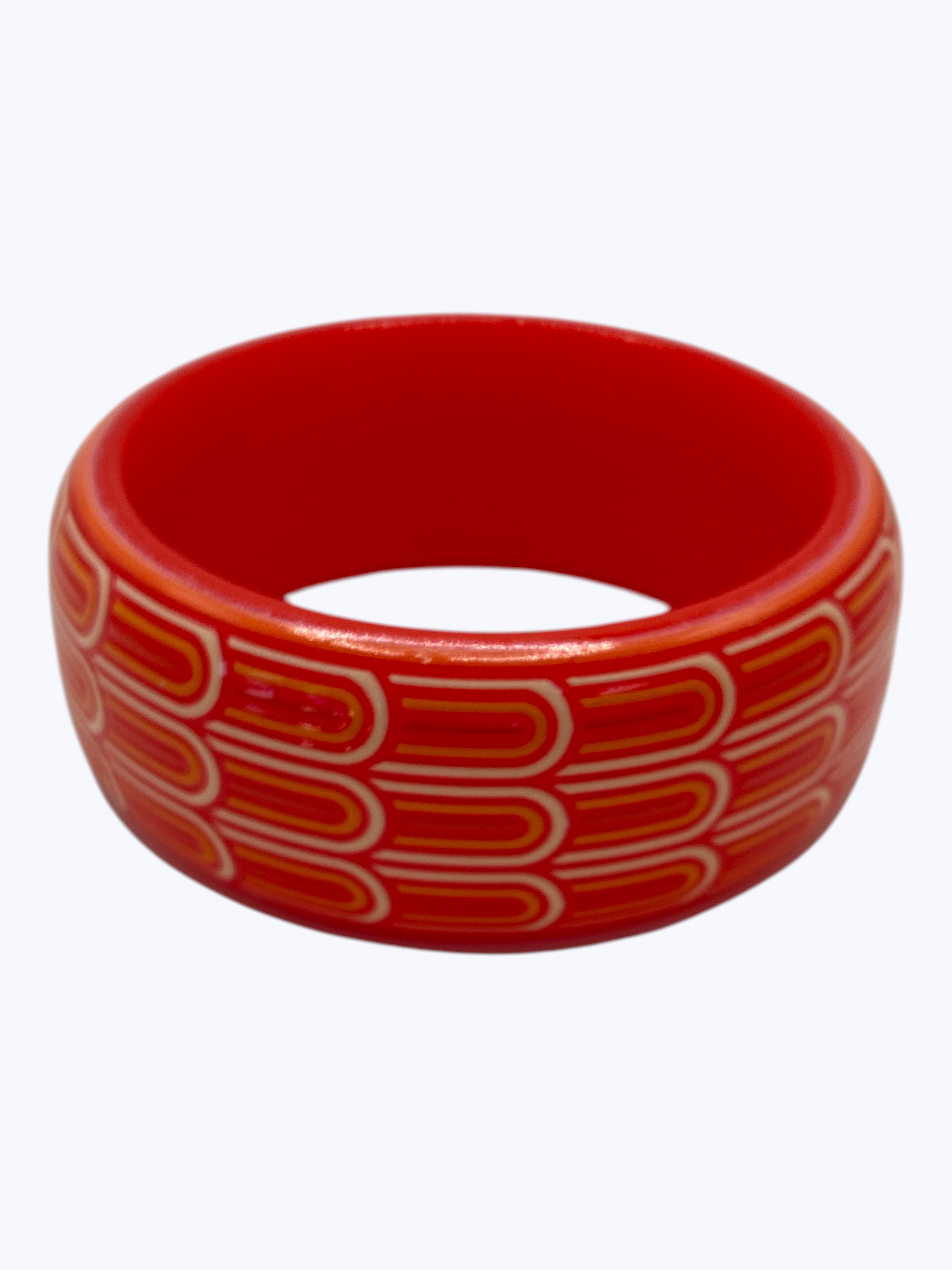 Red bangle with white pattern on a white background