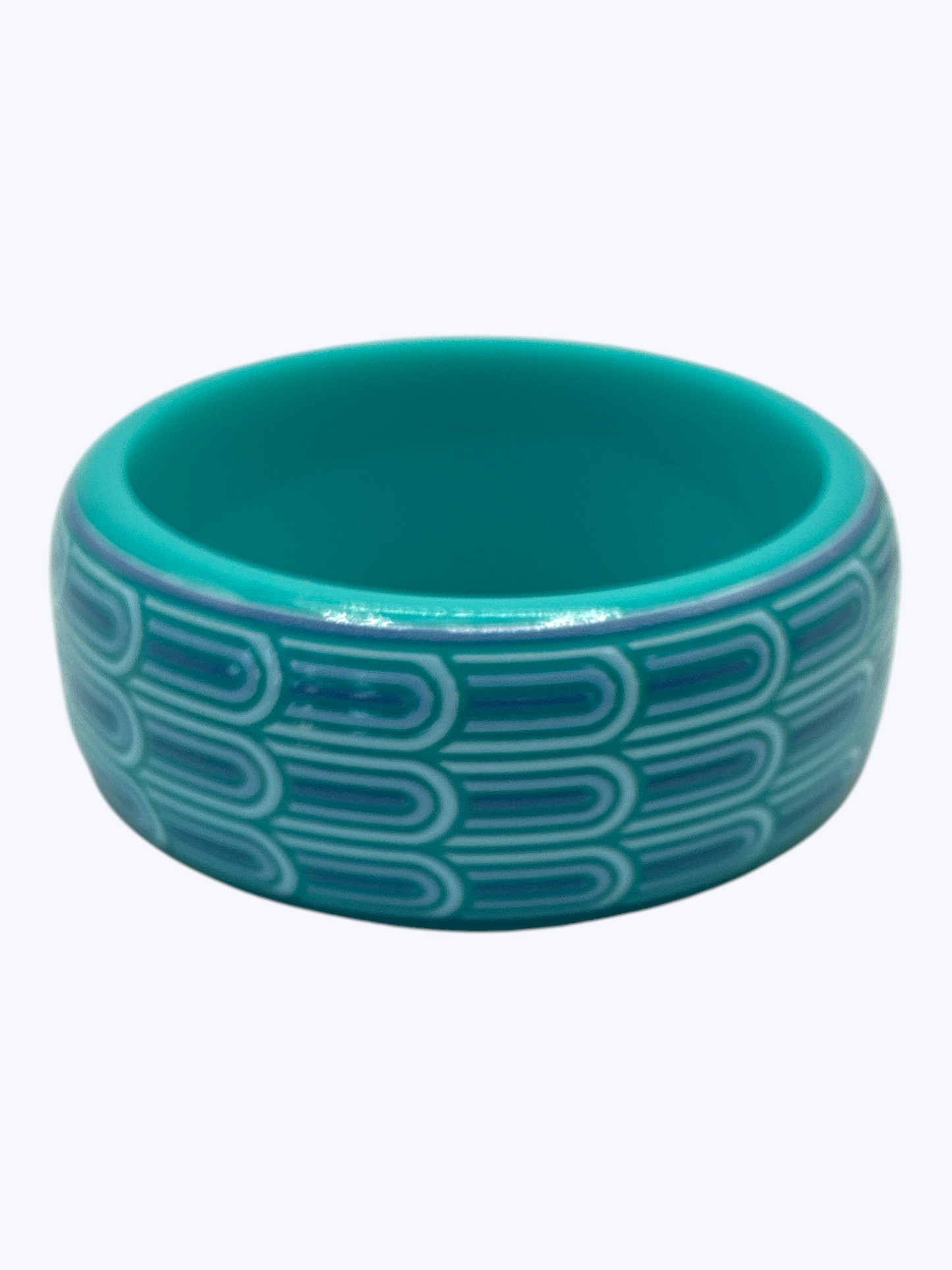 Turquoise bracelet with a geometric pattern on a white background